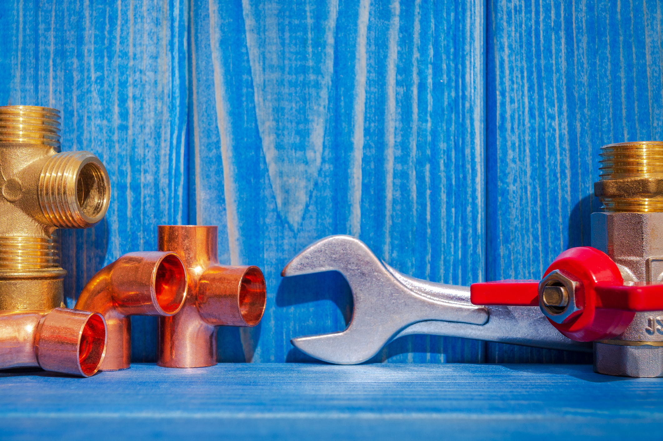 Plumbing Parts on Blue Wood