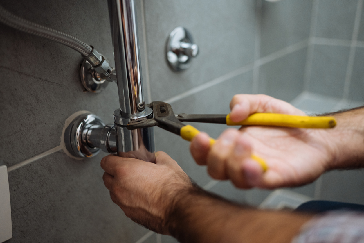 Plumber working on pipe